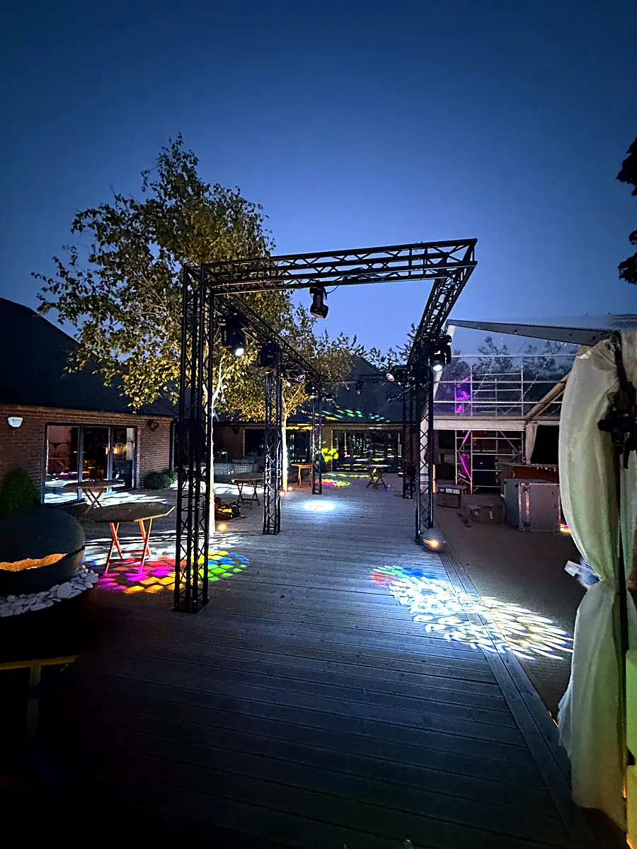 Truss walkway with gobo patterns at blue hour