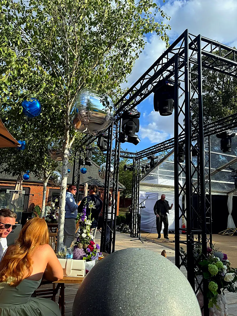 Truss towers and mirror balls at a garden party